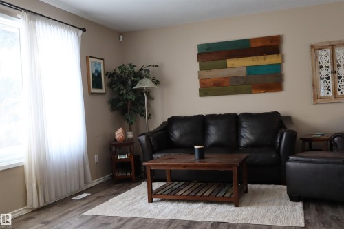 Living room featuring wood finished floors and baseboards - 5220 - 56 Street, Barrhead, AB - Indoor Photo Showing Living Room