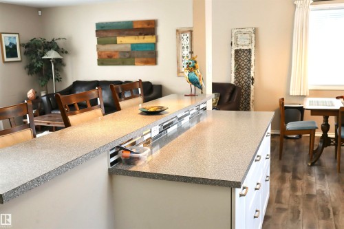 Kitchen featuring dark wood-style flooring and a breakfast bar - 5220 - 56 Street, Barrhead, AB - Indoor Photo Showing Dining Room