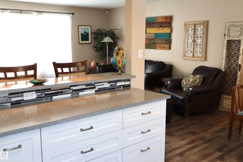 Kitchen with white cabinetry and dark wood-style flooring - 5220 - 56 Street, Barrhead, AB - Indoor