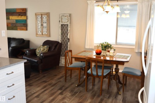 Dining room with dark wood finished floors and suspended lighting - 5220 - 56 Street, Barrhead, AB - Indoor Photo Showing Dining Room