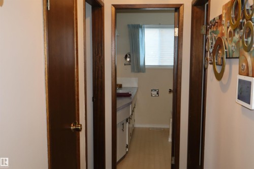 Hallway featuring baseboards - 5220 - 56 Street, Barrhead, AB - Indoor