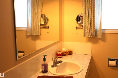 Bathroom with vanity and a wainscoted wall - 5220 - 56 Street, Barrhead, AB - Indoor Photo Showing Bathroom