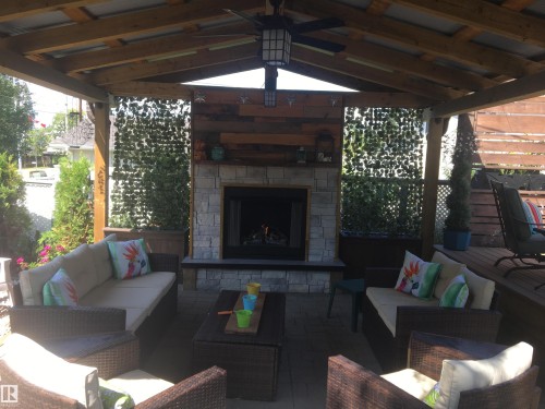 View of patio / terrace featuring an outdoor living space with a fireplace - 5220 - 56 Street, Barrhead, AB - Outdoor With Fireplace With Deck Patio Veranda With Exterior