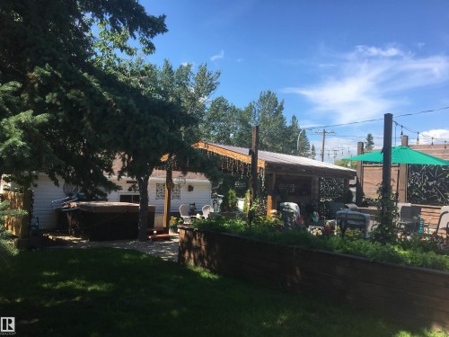 Back of property with a lawn and a patio - 5220 - 56 Street, Barrhead, AB - Outdoor