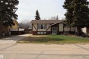 Exterior featuring a gabled roof, light-colored siding, dark trim, and a brick foundation - 5220 - 56 Street, Barrhead, AB  - Outdoor 