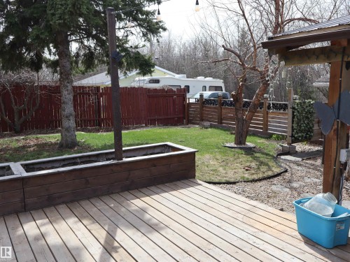 Wood-finish deck with an integrated planter box - 5220 - 56 Street, Barrhead, AB - Outdoor With Deck Patio Veranda