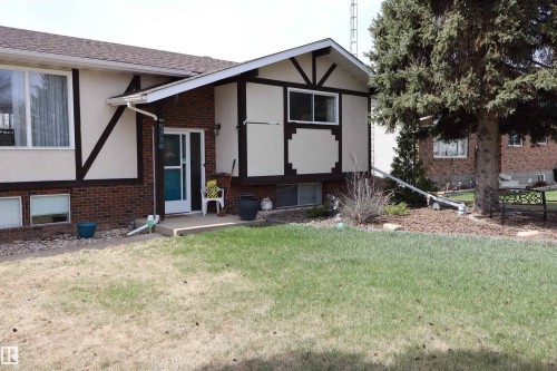 Mid-century residence featuring a brick and stucco exterior with decorative timber accents - 5220 - 56 Street, Barrhead, AB - Outdoor