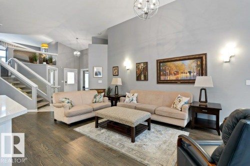 Living area featuring hanging lights, wood finished floors, and vaulted ceiling - 8 Osborne Close, St. Albert, AB - Indoor Photo Showing Living Room