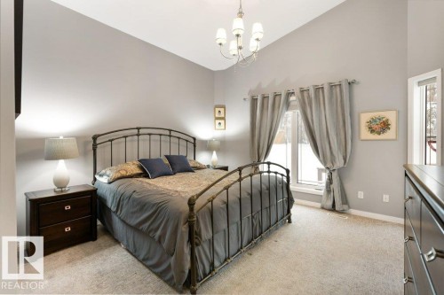 Bedroom featuring lofted ceiling, suspended lighting, and light carpet - 8 Osborne Close, St. Albert, AB - Indoor Photo Showing Bedroom