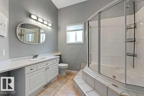 Full bath with a combined bath / shower with jetted tub and vanity - 8 Osborne Close, St. Albert, AB - Indoor Photo Showing Bathroom