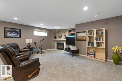 Living area featuring a fireplace, light colored carpet, and recessed lighting - 8 Osborne Close, St. Albert, AB - Indoor With Fireplace