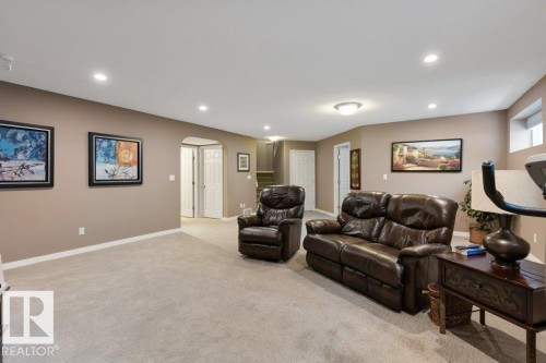 Living room with arched walkways, light colored carpet, and recessed lighting - 8 Osborne Close, St. Albert, AB - Indoor