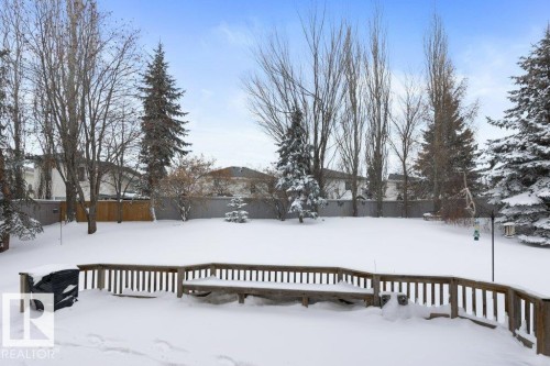 Yard layered in snow featuring a wooden deck - 8 Osborne Close, St. Albert, AB - Outdoor