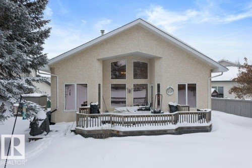 Snow covered property featuring a wooden deck and stucco siding - 8 Osborne Close, St. Albert, AB - Outdoor