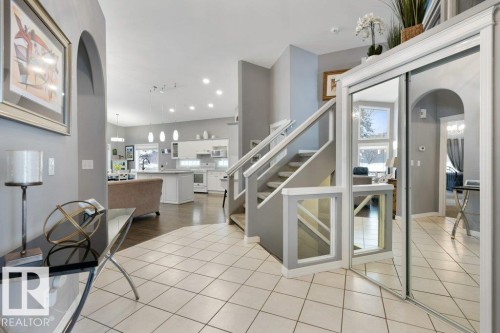 Stairs featuring arched walkways, tile patterned flooring, and recessed lighting - 8 Osborne Close, St. Albert, AB - Indoor Photo Showing Other Room