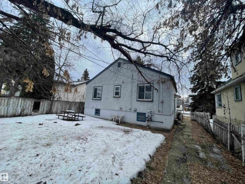 Back of house featuring a fenced backyard and stucco siding - 11250 72 Avenue, Edmonton, AB - Outdoor