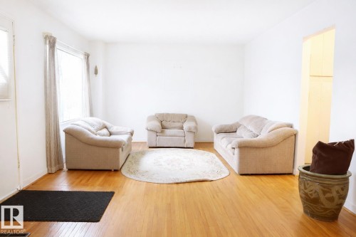 Living area featuring hardwood / wood-style floors and baseboards - 11250 72 Avenue, Edmonton, AB - Indoor Photo Showing Living Room