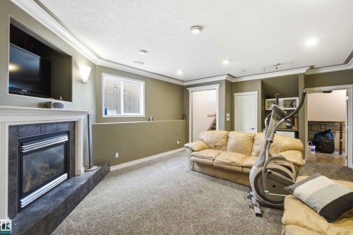 1304 Oakland Crescent, Devon, AB - Indoor Photo Showing Living Room With Fireplace