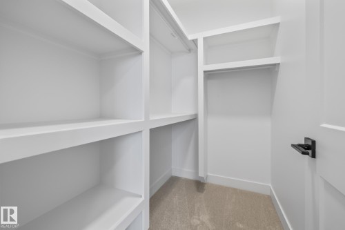Walk in closet featuring light carpet - 132 Edgewater Circle, Leduc, AB - Indoor With Storage