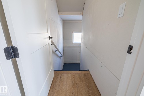 This area features light-colored walls and a window providing natural light - 132 Edgewater Circle, Leduc, AB - Indoor Photo Showing Other Room