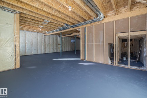 Spacious unfinished basement with exposed wooden joists and insulated walls, offering significant potential for customization - 132 Edgewater Circle, Leduc, AB - Indoor Photo Showing Basement