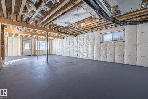 The expansive unfinished basement provides a blank canvas for future customization, featuring exposed ceiling joists, insulation on the walls, and a finished concrete floor - 132 Edgewater Circle, Leduc, AB - Indoor Photo Showing Basement