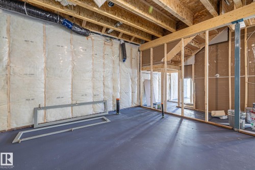 The property features an unfinished basement with exposed wooden beams and floor joists - 132 Edgewater Circle, Leduc, AB - Indoor Photo Showing Basement