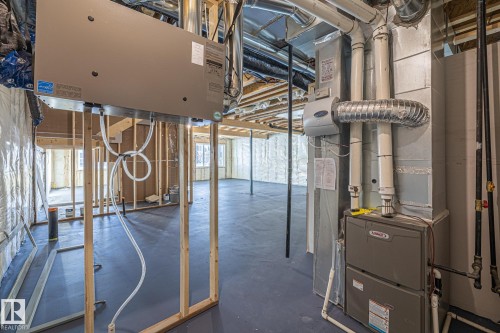 The property features a utility area with exposed ductwork and a visible Lennox furnace - 132 Edgewater Circle, Leduc, AB - Indoor Photo Showing Basement