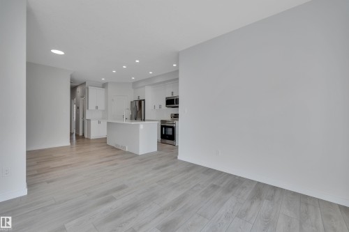 Unfurnished living room featuring light wood-type flooring and recessed lighting - 2275 Alces Drive, Edmonton, AB - Indoor Photo Showing Kitchen