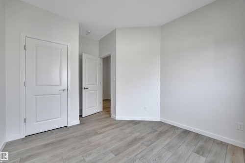 Unfurnished bedroom featuring baseboards and light wood-style floors - 2275 Alces Drive, Edmonton, AB - Indoor Photo Showing Other Room