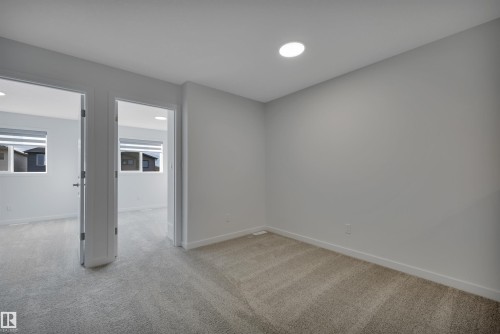 Spare room with light colored carpet and baseboards - 2275 Alces Drive, Edmonton, AB - Indoor Photo Showing Other Room
