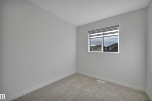 Empty room with baseboards and light carpet - 2275 Alces Drive, Edmonton, AB - Indoor Photo Showing Other Room