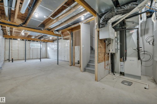 Basement featuring stairway and heating unit - 2275 Alces Drive, Edmonton, AB - Indoor Photo Showing Basement
