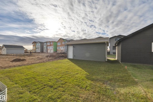 View of grassy yard featuring a residential view - 2275 Alces Drive, Edmonton, AB - Outdoor