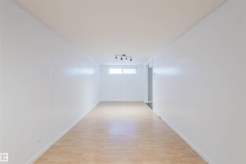 Corridor featuring light wood-style flooring and rail lighting - 6048 105B Street Nw, Edmonton, AB - Indoor Photo Showing Other Room