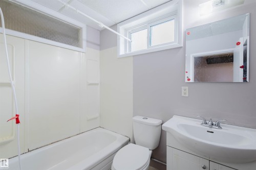 Bathroom featuring vanity and washtub / shower combination - 6048 105B Street, Edmonton, AB - Indoor Photo Showing Bathroom