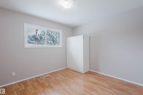 Unfurnished bedroom with light wood-style floors and a closet - 6048 105B Street Nw, Edmonton, AB - Indoor Photo Showing Other Room