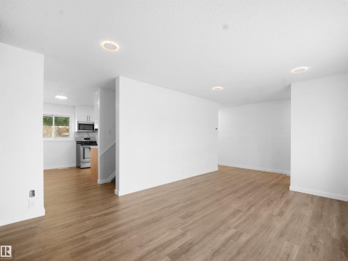 Empty room with light wood-style flooring, recessed lighting, and a textured ceiling - 10329 132 Avenue, Edmonton, AB - Indoor Photo Showing Other Room