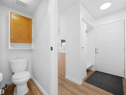 Half bath featuring light wood-type flooring and vanity - 10329 132 Avenue, Edmonton, AB - Indoor Photo Showing Bathroom