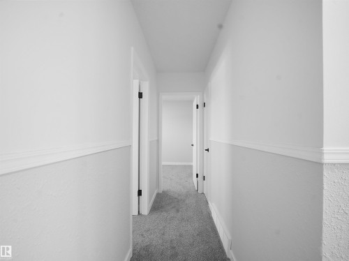 Corridor featuring carpet floors and a textured wall - 10329 132 Avenue, Edmonton, AB - Indoor Photo Showing Other Room