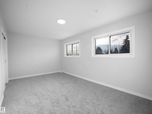 Unfurnished bedroom featuring light colored carpet and a closet - 10329 132 Avenue, Edmonton, AB - Indoor Photo Showing Other Room