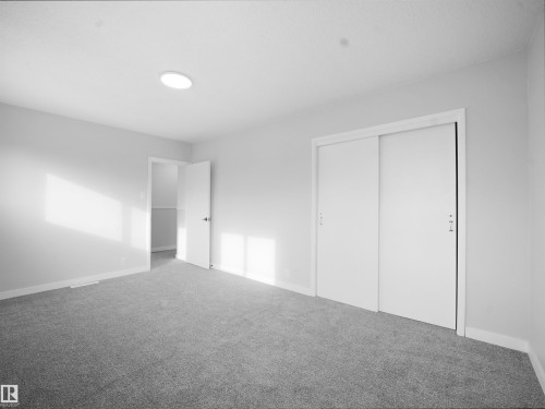Unfurnished bedroom featuring a closet and carpet - 10329 132 Avenue, Edmonton, AB - Indoor Photo Showing Other Room