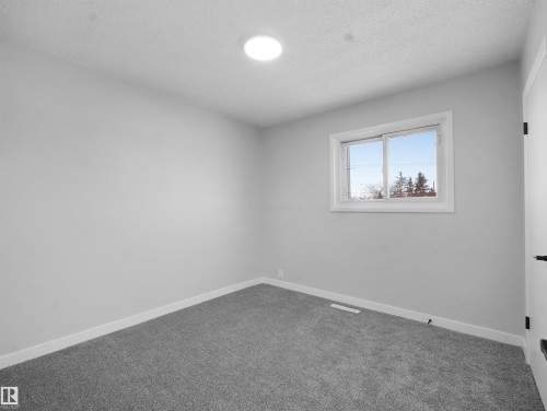 Spare room featuring carpet flooring and a textured ceiling - 10329 132 Avenue, Edmonton, AB - Indoor Photo Showing Other Room