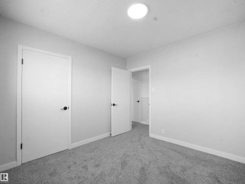 Unfurnished bedroom with carpet and a textured ceiling - 10329 132 Avenue, Edmonton, AB - Indoor Photo Showing Other Room