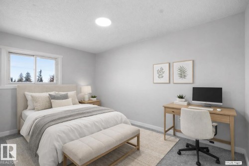 Carpeted bedroom with an office area and a textured ceiling - 10329 132 Avenue, Edmonton, AB - Indoor Photo Showing Bedroom