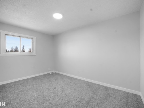 Bedroom with carpet and a textured ceiling - 10329 132 Avenue, Edmonton, AB - Indoor Photo Showing Other Room
