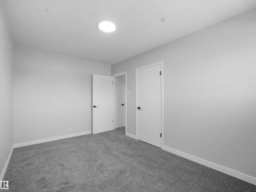 Unfurnished bedroom featuring baseboards and carpet floors - 10329 132 Avenue, Edmonton, AB - Indoor Photo Showing Other Room