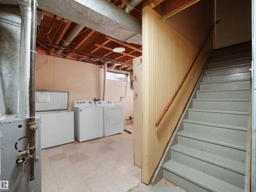 Basement featuring tile patterned floors, washing machine and clothes dryer, and heating unit - 10329 132 Avenue, Edmonton, AB - Indoor Photo Showing Laundry Room