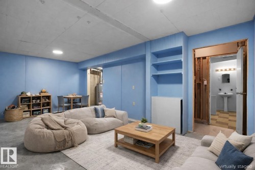 Living room with concrete flooring and gas water heater - 10329 132 Avenue, Edmonton, AB - Indoor