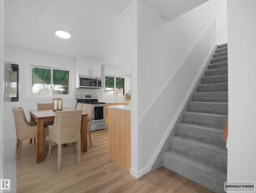 Dining space with stairs and light wood finished floors - 10329 132 Avenue, Edmonton, AB - Indoor